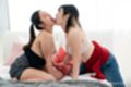 Kneeling on bed girls kissing